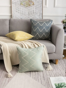 Detailed close-up of modern geometric jacquard throw pillow covers in a home setting