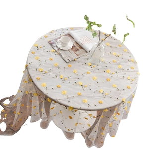 Modern floral embroidered table runner with yellow flowers on translucent mesh fabric