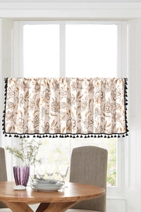 Detailed view of floral cafe curtain with elegant black tassels and rustic linen texture