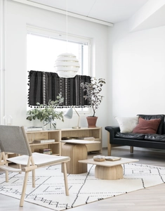 Detail of black geometric pattern cafe curtain with stylish fringe and cotton texture