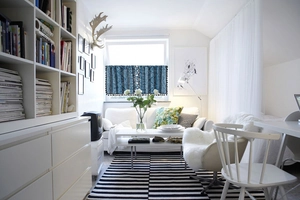 Detail of dark blue geometric short curtain with white patterns and black tassel fringe