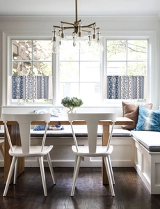 Close-up of blue and white bohemian geometric floral patterns on small kitchen cafe curtains
