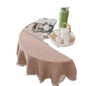 Elegant jacquard linen tablecloth with hollow lace edges and decorative tassels on white