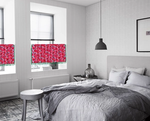 Detail of red floral cafe curtain with green fringe trim for kitchen and cabinet decor