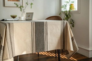 Close-up of linen striped tablecloth texture under warm natural sunlight and shadows