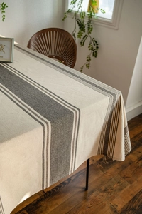 Detailed view of striped linen tablecloth with soft drape and heavy canvas texture