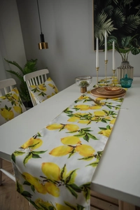 Detail view of table runner and chair cushions with vibrant lemon floral print