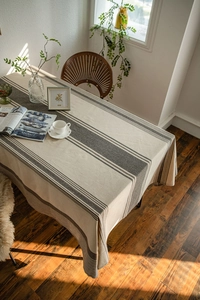 Detail view of Japanese style striped linen tablecloth with neat stitching and drape