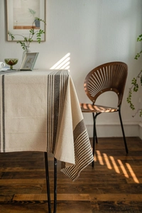 Detailed texture of brown striped linen tablecloth with natural rustic fabric finish