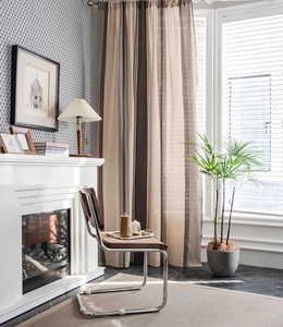 Detailed texture of brown and beige striped cotton linen curtains in a cozy living room