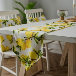 Table runner and chair pads with yellow lemon print for rustic dining decor