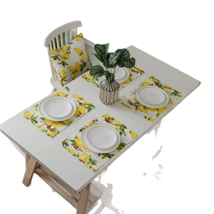 Pastoral table runner and placemat set with vibrant yellow lemon and leaf pattern
