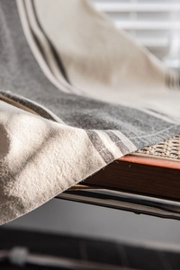 Detailed macro view of American coffee striped cotton linen fabric texture on a rattan chair