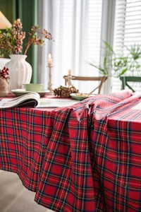 Close-up of red plaid tablecloth with classic tartan patterns and festive decor