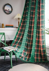 Detailed view of British vintage green plaid curtain with lace trim and tassel decor