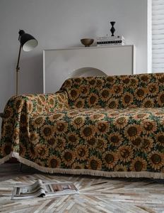 Detail of sunflower jacquard sofa throw with cream fringes in rustic retro style