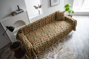 Close-up of thick sunflower jacquard sofa cover with fringe edges and vintage texture