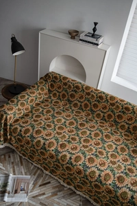 Detail of sunflower jacquard sofa cover with tassel fringe in vintage aesthetic