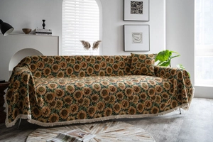 Detailed jacquard sunflower throw blanket on sofa with elegant tassel edges