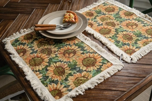Macro detail of sunflower jacquard woven placemat with cream tassels on wood