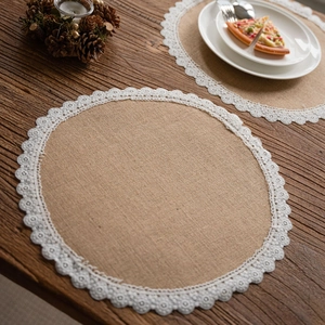 Natural jute table placemats with white lace edges set on a rustic wooden dining table