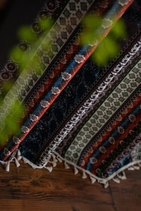 Detail of bohemian printed curtain with mandala patterns and white fringe tassels decoration