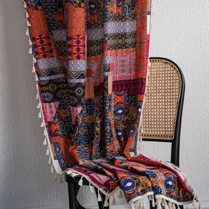 Bohemian printed throw blanket with colorful geometric patterns and white tassels