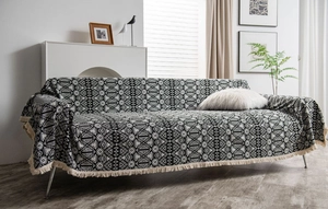 Detail shot of the black and white geometric pattern sofa throw with fringe edges