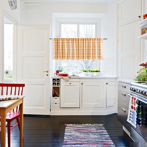 Orange and white checkered cafe curtain with fringe trim for kitchen window decor