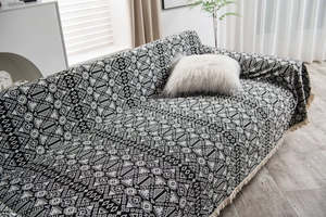 Detailed close-up of geometric jacquard fabric with tassels for American rural style sofa