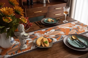 Close-up of harvest corn pattern jacquard table runner with textured orange fabric