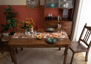Close-up of jacquard table runner with autumn sunflower and grain patterns for dining decor
