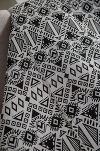 Macro shot of geometric jacquard fabric showing precision stitching and woven texture