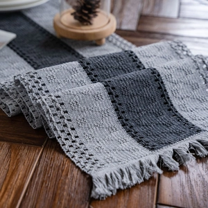 Gray cotton striped table runner with handmade tassels and woven hollow patterns