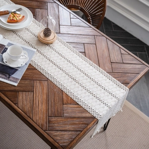 Bohemian cream woven table runner with hollow geometric patterns and tassels