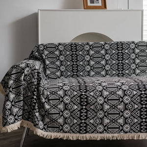 Bohemian geometric throw blanket with black and white jacquard pattern and tassels