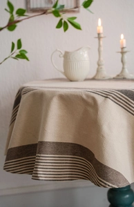 Detailed close-up of navy blue striped cotton linen tablecloth with natural drape and texture