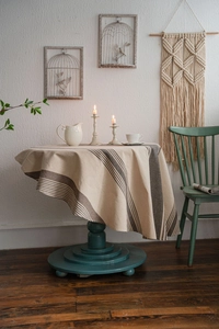 Detailed view of striped linen round tablecloth with premium drape and vintage style