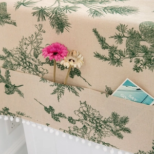 Linen dust cover with green pine needle print and white pom-pom trim for refrigerator