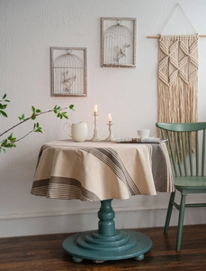 Detailed texture of round cotton linen tablecloth with vintage navy blue stripes
