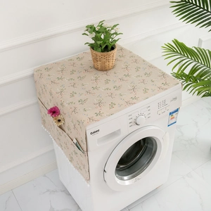 Detail of floral refrigerator dust cover with side storage pockets and white pom pom trim
