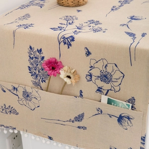 Floral refrigerator dust cover with blue flowers and storage pockets with tassels