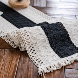 Handwoven black and white striped cotton table runner with decorative fringe tassels