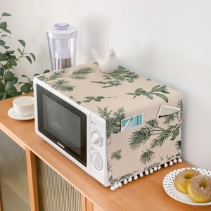Linen dust cover for microwaves with green pine needles, birds, and side storage pockets