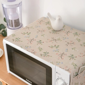 Floral cotton linen microwave dust cover with side storage pockets in a home setting
