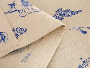 Detail of blue floral print on linen fabric with high-quality edge stitching craftsmanship