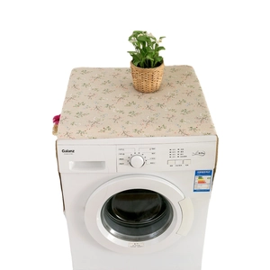 Floral print dust cover for washing machines with cream background and small orange flowers