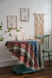 Detailed view of bohemian round tablecloth featuring mandala patterns and edge tassels