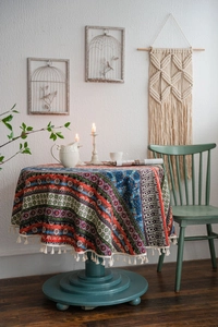 Detailed view of bohemian style round tablecloth featuring colorful geometric patterns and tassels