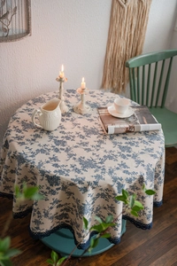 Detailed view of floral blue pattern and lace edge on cotton linen tablecloth
